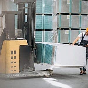 young-man-working-warehouse-with-boxes_1303-16632